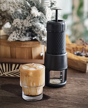 A Staresso classic portable coffee maker with a coffee drink.