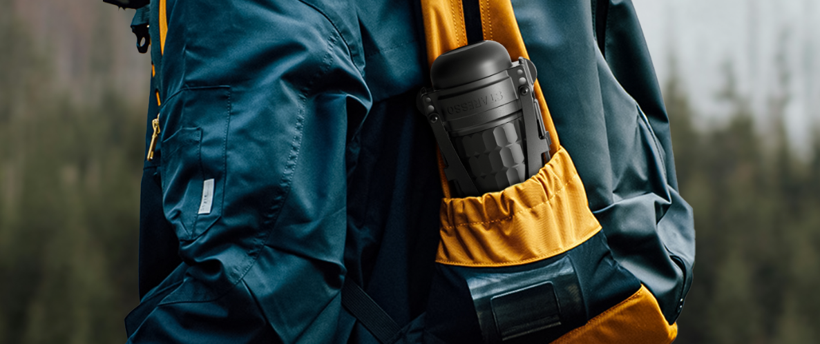 a person with a staresso plus portable coffee maker in his bag